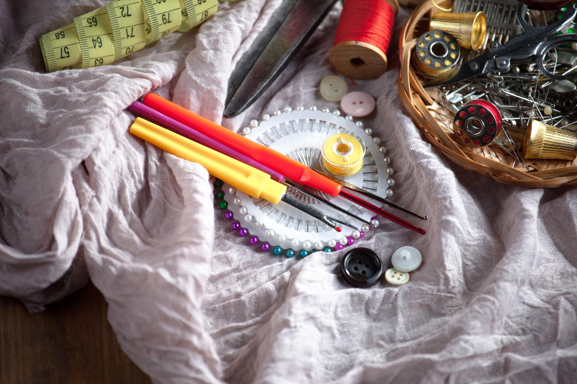 Artisan arranging silk threads and needles